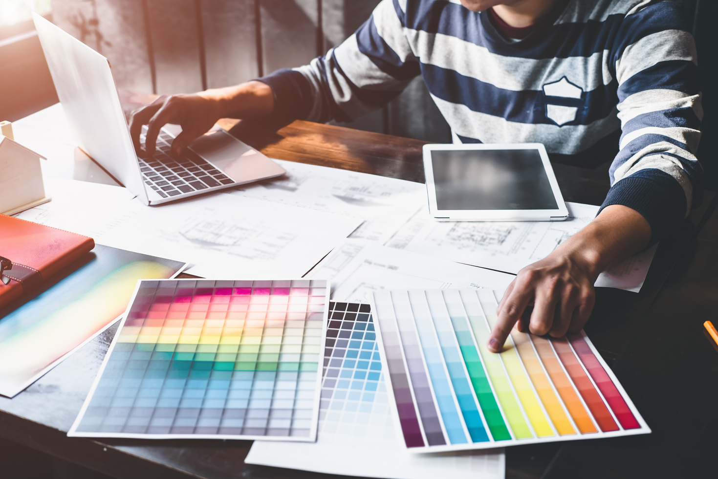Graphic Designer Choosing Color While Typing on Laptop